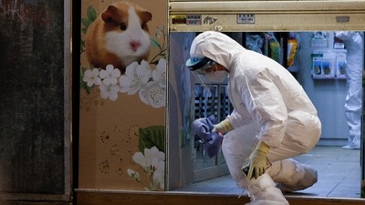 A wildlife officer wearing personal protective equipment leaves a temporarily closed pet shop in Hong Kong, China. (Reuters)