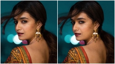 Keerthy's ensemble features a sleeveless linen anarkali in a bright red shade. It has a flowy silhouette, spaghetti straps, a plunging neckline, sequins and beaded embroidery, and intricate thread work done on the torso. She teamed the slip anarkali with matching pants. (Instagram/@keerthysureshofficial) Keerthy's ensemble features a sleeveless linen anarkali in a bright red shade. It has a flowy silhouette, spaghetti straps, a plunging neckline, sequins and beaded embroidery, and intricate thread work done on the torso. She teamed the slip anarkali with matching pants. (Instagram/@keerthysureshofficial)