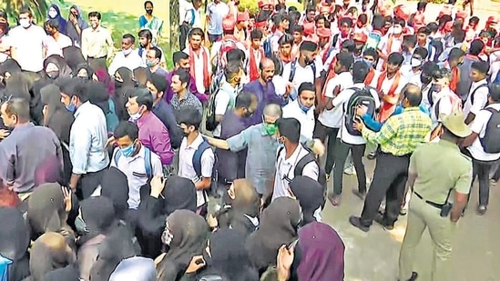 Udupi, Feb 08 (ANI): Protests erupt between students who wearing hijab and another group of students wearing saffron stoles and headgears, at Mahatma Gandhi Memorial College in Udupi on Tuesday. (ANI Photo) (ANI)