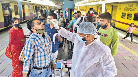 A health worker collects a swab sample of a passenger at Dadar station in Mumbai on Tuesday. Anshuman Poyrekar/HT photo