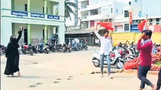 Video grab of a burqa-clad student being heckled by a group at a pre-university college in Karnataka’s Mandya district. (ANI)