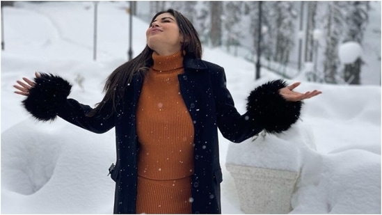 Mouni Roy enjoys snowfall on Kashmir honeymoon with Suraj Nambiar in monotone sweater and skirt set Mouni rounded off the winter outfit with red and white wedding bangles, gold bracelets, and a statement ring adorned with a diamond. In the end, the star rounded off her look with centre-parted open tresses, nude lip shade, blushed glow, subtle smoky eye shadow, and mascara-adorned lashes.(Instagram/@imouniroy)