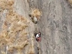 Kerala trekker R Babu is sitting in a small recess on the mountain face.(ANI Photo) Kerala trekker R Babu is sitting in a small recess on the mountain face.(ANI Photo)