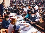 Polling officials at an election material distribution centre, a day before the Uttar Pradesh Assembly elections, in Noida, Wednesday, February. 9, 2022. (PTI Photo)