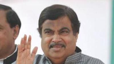 President of the Bharatiya Janta Party (BJP) Nitin Gadkari (R) waves to supporters during an election rally in Noida, Uttar Pradesh. AFP/Sajjad Hussain