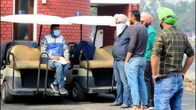The UT administration employee challaning mask violators at Sukhna Lake in Chandigarh on Wednesday. (Ravi Kumar/HT)