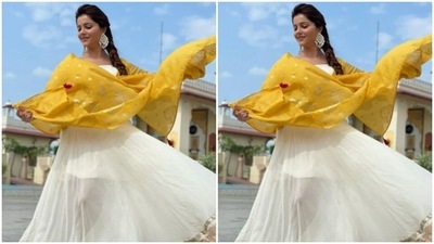 Rubina's anarkali gown came with thick golden borders and a gold zari detail near the feet. Rubina added more ethnic vibes to her attire with a contrasting bright yellow satin dupatta embellished in gold details. (Instagram/@rubinadilaik)