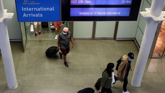 Passengers wearing protective face masks arrive from Paris at Eurostar terminal at St Pancras station, as Britain imposes a 14-day quarantine on arrival from France from Saturday, following the outbreak of the coronavirus disease (COVID-19), in London, Britain August 14, 2020. REUTERS/Peter Nicholls