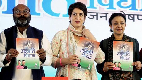 Congress general secretary Priyanka Gandhi Vadra releasing the party manifesto for the UP polls in Lucknow on Wednesday. UP Congress president Ajay Kumar Lallu and Congress Legislature Party leader Aradhana Mishra are with her. (ANI Photo)