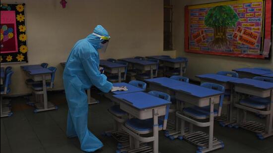 Gurugram, India - Feb. 09, 2022: A worker in PPE coveralls chemically disinfects the premises at a school, in Gurugram, India, on Wednesday, February 09, 2022. (Photo by Vipin Kumar / Hindustan Times) **To go with Leena Dhankar’s story** (Vipin Kumar /HT PHOTO)