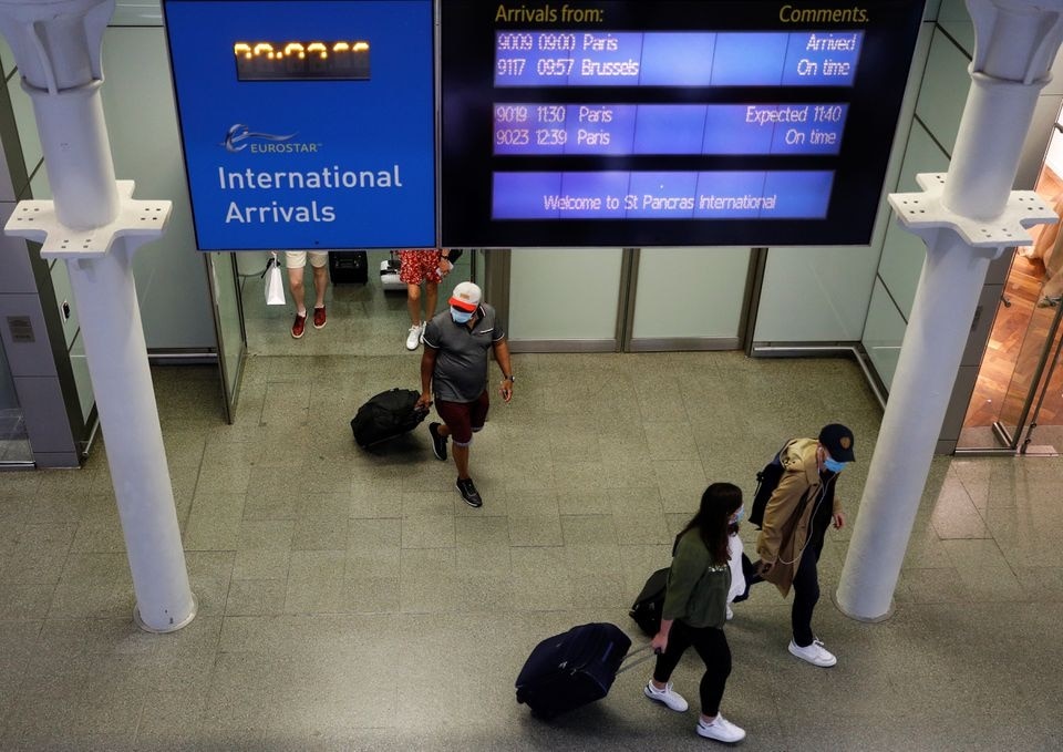 Passengers wearing protective face masks arrive from Paris at Eurostar terminal at St Pancras station, as Britain imposes a 14-day quarantine on arrival from France from Saturday, following the outbreak of the coronavirus disease (COVID-19), in London, Britain August 14, 2020. REUTERS/Peter Nicholls Passengers wearing protective face masks arrive from Paris at Eurostar terminal at St Pancras station, as Britain imposes a 14-day quarantine on arrival from France from Saturday, following the outbreak of the coronavirus disease (COVID-19), in London, Britain August 14, 2020. REUTERS/Peter Nicholls