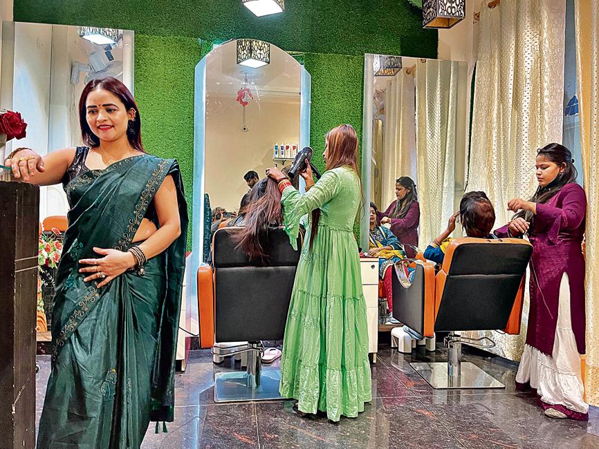 The beauty salon's walls are adorned with marigold garlands brought from the flower market in Mehrauli.