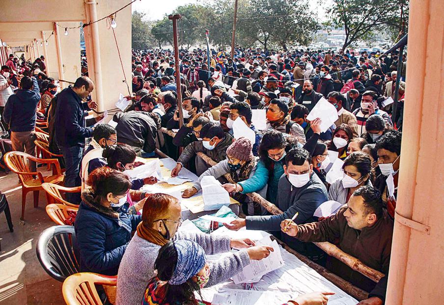Polling officials at an election material distribution centre, a day before the Uttar Pradesh Assembly elections, in Noida, Wednesday, February. 9, 2022. (PTI Photo) Polling officials at an election material distribution centre, a day before the Uttar Pradesh Assembly elections, in Noida, Wednesday, February. 9, 2022. (PTI Photo)