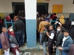 Voters wait in queues to cast their votes at Children Academy School during the first phase of the Uttar Pradesh Assembly elections, in Aligarh.(ANI photo)