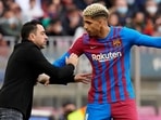 Xavi Hernandez head coach of Barcelona gives instructions to Ronald Araujo.