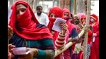 Women stand in a queue to cast their votes, during the first phase of UP polls, at a polling station at Vaidpura village, in Gautam Buddha Nagar on Thursday. (PTI)