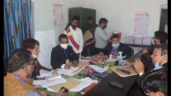 A returning officer busy in scrutiny of nomination papers in Prayagraj on Wednesday. (HT photo)