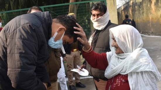 Chandra Prakash Singh, the district magistrate of Bulandshahar blessed by an elderly woman.&nbsp;(HT Photo)