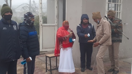 Safety first: Staff members of a polling station in Meerut cantt equipped with temperature scanner and sanitizers in view of the Covid-19 pandemic(HT Photo)