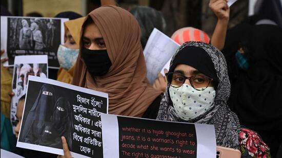 Muslim women hold placards during a protest against the recent hijab ban in few educational institutes of Karnataka state, in Kolkata on Thursday. (AFP)