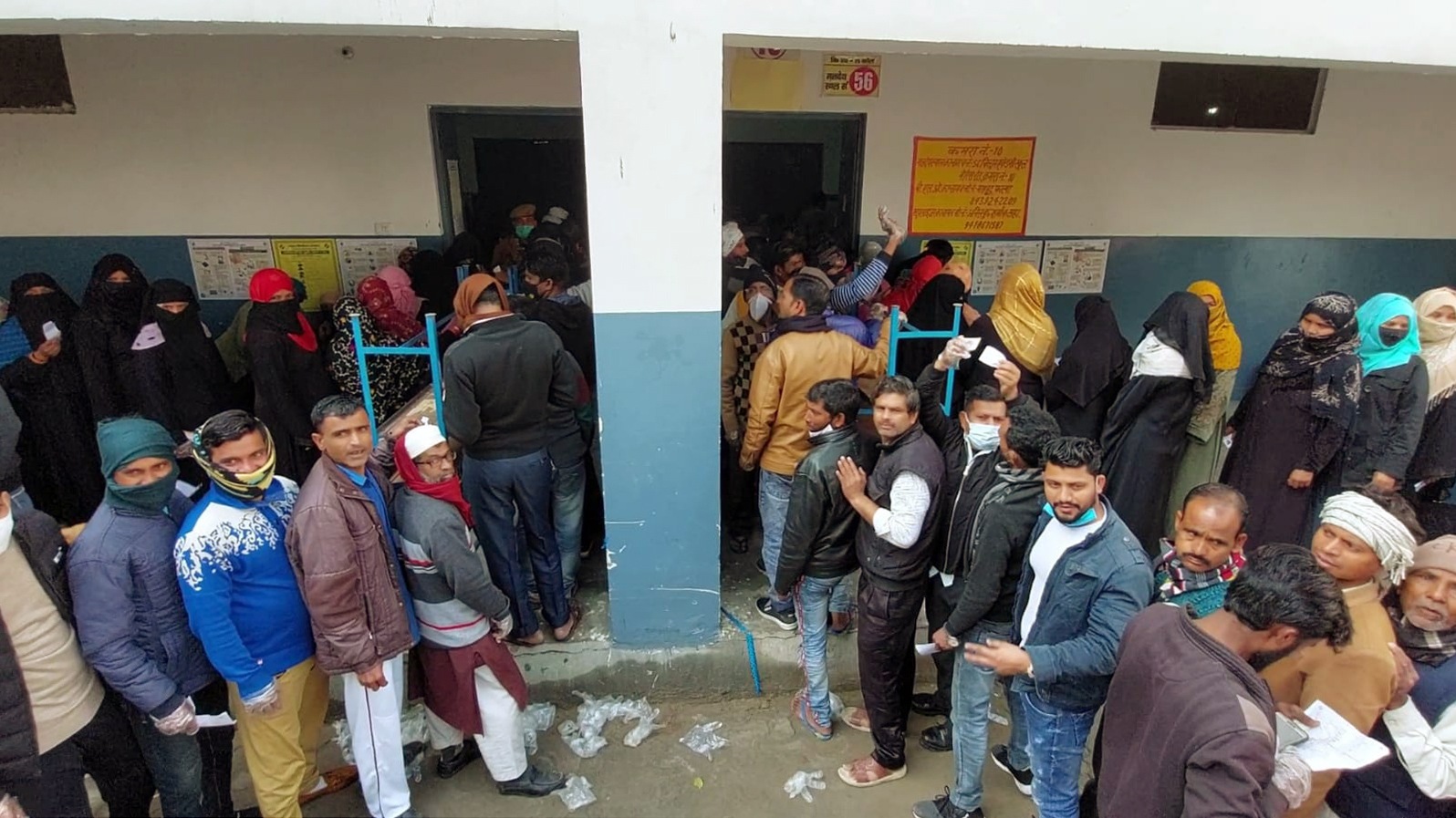 Voters wait in queues to cast their votes at Children Academy School during the first phase of the Uttar Pradesh Assembly elections, in Aligarh. (ANI photo)