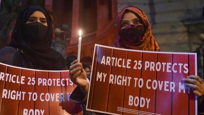 Muslim women protest against the hijab ban in Karnataka educational institutes, in Kolkata on Friday, February 11, 2022. (PTI) Muslim women protest against the hijab ban in Karnataka educational institutes, in Kolkata on Friday, February 11, 2022. (PTI)