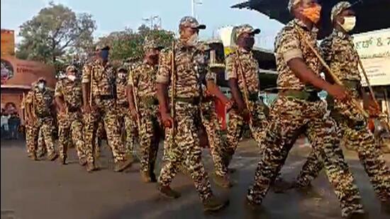 Police during a flag march, in Udupi on Friday. (ANI)