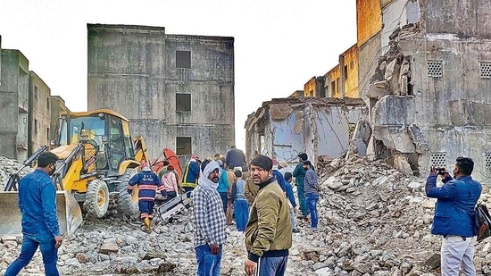 Rescue work in progress after a portion of a building collapsed in a JJ Colony at Bawana, in New Delhi, Friday, Feb 11, 2022. Several people are feared to be trapped in the debris. (PTI Photo)