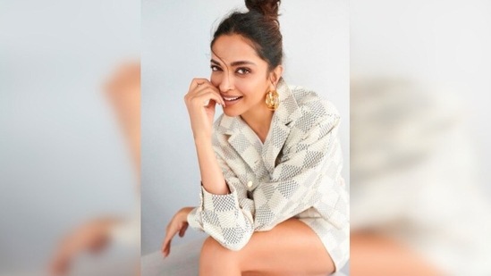 Deepika Padukone raised the glamour quotient as she posed in a grey and white checkered blazer and skirt set teamed with a basic white t-shirt.( shaleenanathani)