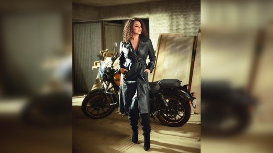 Posing like a boss lady with a Royal Enfield in the background, Sonakshi Sinha nailed the biker girl look.(Instagram/@aslisona)