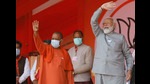Prime Minister Narendra Modi and chief minister Yogi Adityanath waving towards the crowd during an election rally in Kasganj on Friday (Agency)