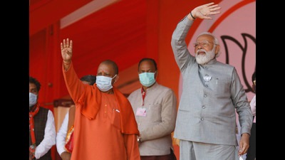 Prime Minister Narendra Modi and chief minister Yogi Adityanath waving towards the crowd during an election rally in Kasganj on Friday (Agency)