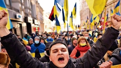 Demonstrators with Ukrainian national flags, one of them shouts, rally against Russian aggression in the center of Kharkiv, Ukraine's second-largest city (AP).
