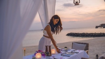 On Saturday, Pooja took to Instagram to share several photos from her mother's beachside birthday celebrations that involved a candlelight dinner under a white canopy during a stunning sunset, surrounded by glittering lamps and beautiful decorations. (Instagram/@hegdepooja) On Saturday, Pooja took to Instagram to share several photos from her mother's beachside birthday celebrations that involved a candlelight dinner under a white canopy during a stunning sunset, surrounded by glittering lamps and beautiful decorations. (Instagram/@hegdepooja)