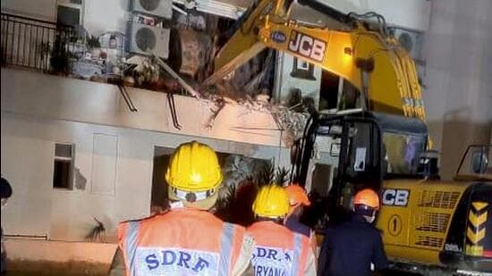 SDRF personnel carry out a rescue operation after a portion of a building of Chintels Paradiso housing society collapsed, in Gurugram, Saturday. (PTI)