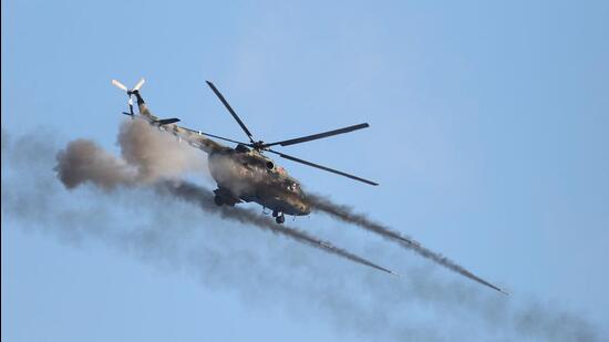 A helicopter fires during joint exercises of the armed forces of Russia and Belarus at the Gozhsky firing range in the Grodno region, on Saturday. (AFP)