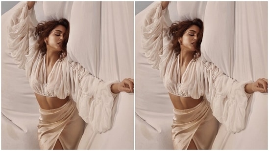 On Friday, Sharvari took to Instagram to share pictures of herself doing an artsy photoshoot and captioned it, "Parda hai parda." She wore a pearl-white ensemble featuring a cropped blouse and a silk satin bodycon skirt. These pictures came after the sunset photoshoot the star did wearing a sheer cut-out dress over a bikini set.(Instagram/@sharvari)