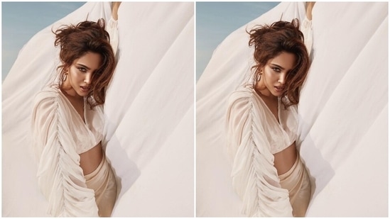 Sharvari posed for the shoot wearing a sheer white linen blouse featuring a plunging V neckline, oversized sleeves with gathered details, cropped hem length, and a billowy silhouette. The star wore the top over a strappy bikini top featuring a sweetheart neckline and animal print.(Instagram/@sharvari)