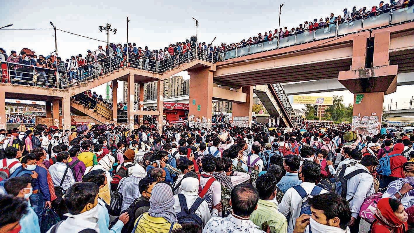 A huge rush of migrant workers at Anand Vihar Bus Terminal in New Delhi, days after the central government announced a nationwide lockdown to contain Covid-19, on March 28, 2020. (Biplov Bhuyan/HT PHOTO) A huge rush of migrant workers at Anand Vihar Bus Terminal in New Delhi, days after the central government announced a nationwide lockdown to contain Covid-19, on March 28, 2020. (Biplov Bhuyan/HT PHOTO)
