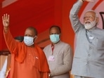 Uttar Pradesh Chief Minister Yogi Adityanath, left, and Indian Prime Minister Narendra Modi wave towards the crowd during an election rally in Kasganj, India, Friday, Feb. 11, 2022. (AP Photo/Rajesh Kumar Singh)(AP)