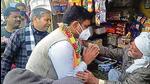 Former Kanpur police commissioner Asim Arun speaks to an elderly man during the campaign for the UP polls in Kannauj Sadar. (HT Correspondent)