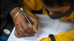 An instructor tends to a student during a cursive writing session at Likhavat Academy, in Kamla Nagar, New Delhi. (Amal KS/HT Photo) An instructor tends to a student during a cursive writing session at Likhavat Academy, in Kamla Nagar, New Delhi. (Amal KS/HT Photo)