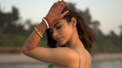 She accessorised the sultry western dress with her engagemnet ring, a simple gold chain and a set of traditional bangles - shaakhaa pola that are worn by Bengali brides where the white bangle is called Shakha and is crafted and polished out of the conch shell and the red coral bangle is called Pola. (Instagram/imouniroy) She accessorised the sultry western dress with her engagemnet ring, a simple gold chain and a set of traditional bangles - shaakhaa pola that are worn by Bengali brides where the white bangle is called Shakha and is crafted and polished out of the conch shell and the red coral bangle is called Pola. (Instagram/imouniroy)