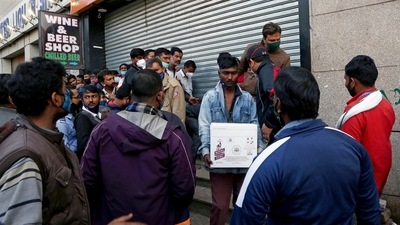 A man carries a box of liquor after purchasing it from a store as prices of liquor were reduced in view of the Delhi Government's new excise police on Saturday. (ANI Photo) A man carries a box of liquor after purchasing it from a store as prices of liquor were reduced in view of the Delhi Government's new excise police on Saturday. (ANI Photo)