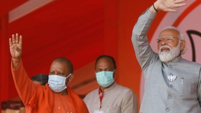 Uttar Pradesh Chief Minister Yogi Adityanath, left, and Indian Prime Minister Narendra Modi wave towards the crowd during an election rally in Kasganj, India, Friday, Feb. 11, 2022. (AP Photo/Rajesh Kumar Singh) (AP) Uttar Pradesh Chief Minister Yogi Adityanath, left, and Indian Prime Minister Narendra Modi wave towards the crowd during an election rally in Kasganj, India, Friday, Feb. 11, 2022. (AP Photo/Rajesh Kumar Singh) (AP)