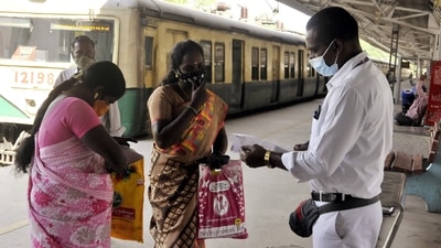 A railway staff checks the Covid-19 vaccination certificates of a passenger before allowing them to board the train in view of Omicron-driven Coronavirus surge, at a railway station in Chennai. (ANI Photo) A railway staff checks the Covid-19 vaccination certificates of a passenger before allowing them to board the train in view of Omicron-driven Coronavirus surge, at a railway station in Chennai. (ANI Photo)