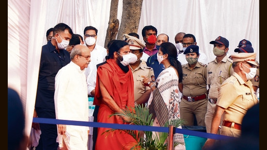 Baba Ramdev (in orange) and Supriya Sule (in saree) were seen at the funeral service of Rahul Bajaj which was held at Vaikunth Smashan Bhumi at Navi Peth on Sunday. (Rahul Raut/HT PHOTO)