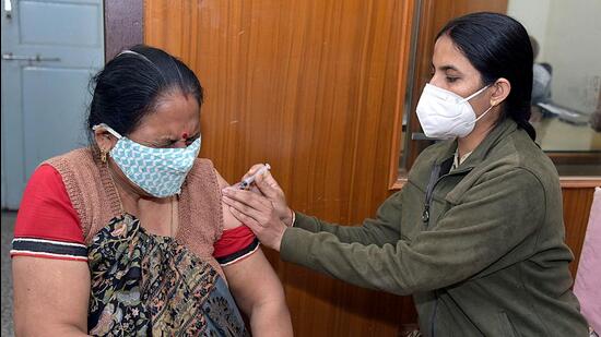 Bikaner, Jan 29 (ANI): A beneficiary reacts while receiving a dose of COVID-19 vaccine during a vaccination drive, at shiv mandir near Jai Narayan Vyas Colony, in Bikaner on Saturday. (ANI Photo) (Dinesh Gupta)