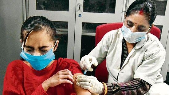 A healthcare worker inoculates a dose of the Covid-19 vaccine to a girl, at a Government Hospital, in Prayagraj. (ANI Photo)