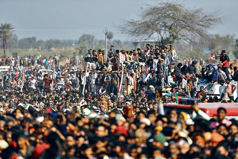 Supporters gather at an election rally addressed by Uttar Pradesh chief minister Yogi Adityanath and Indian Prime Minister Narendra Modi ahead of state elections in Kasganj, Uttar Pradesh, India, Friday, February 11, 2022. (AP Photo/Rajesh Kumar Singh) Supporters gather at an election rally addressed by Uttar Pradesh chief minister Yogi Adityanath and Indian Prime Minister Narendra Modi ahead of state elections in Kasganj, Uttar Pradesh, India, Friday, February 11, 2022. (AP Photo/Rajesh Kumar Singh)